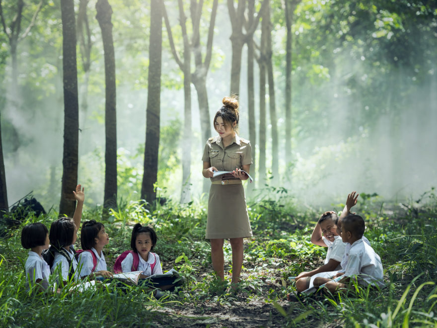 teacher in authority over children in a forest