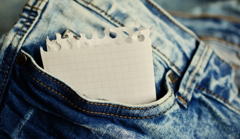 slip of paper for quotations to remember in a jean pant pocket
